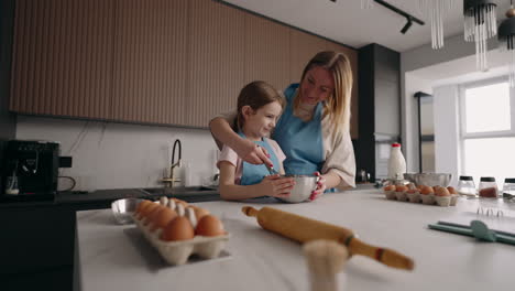 happy-little-girl-and-her-mummy-are-cooking-together-mother-is-teaching-her-daughter-to-cook-family-pass-time-in-home